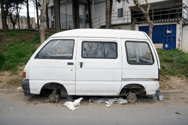 junk van without tires parked on a street